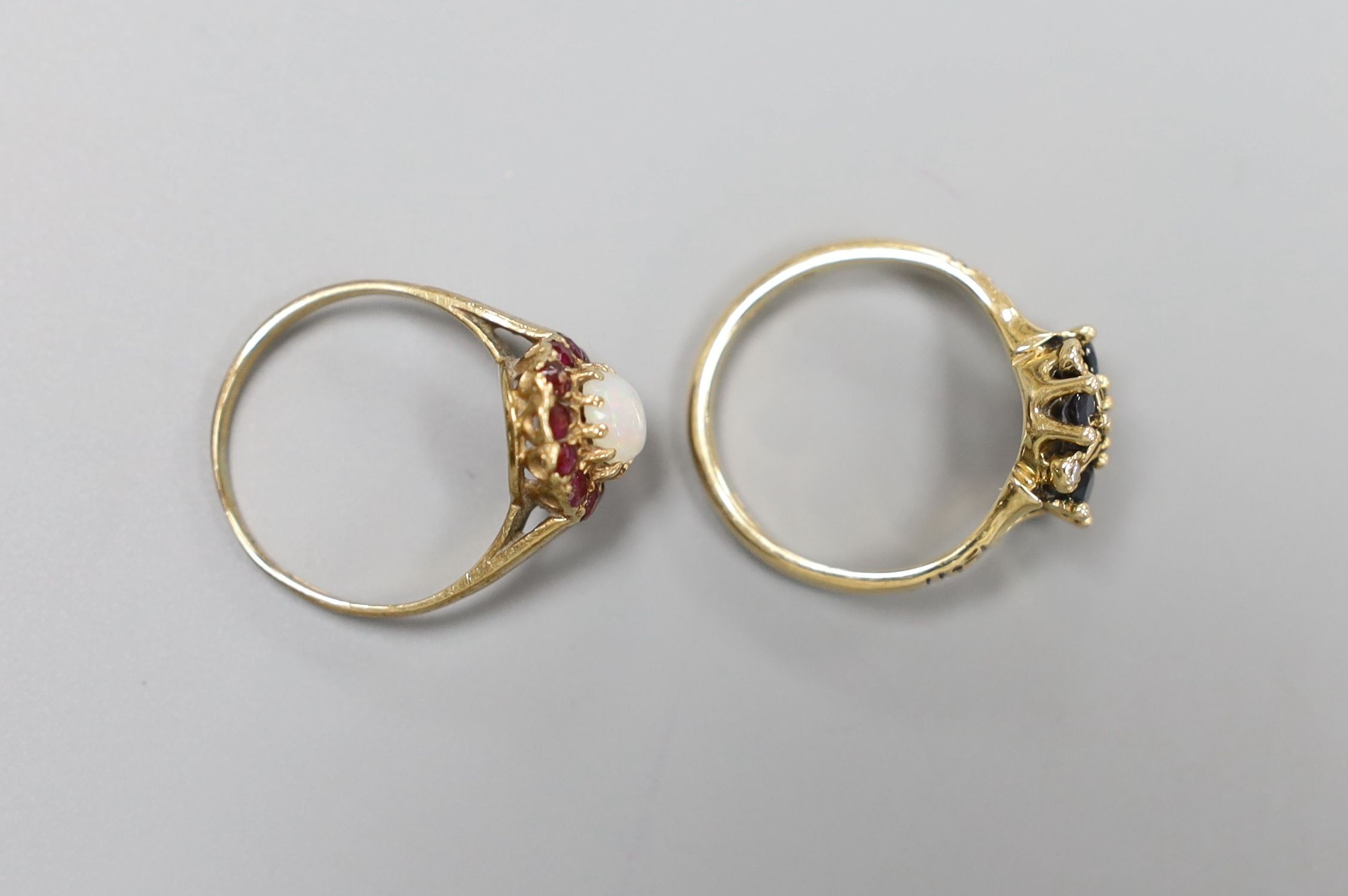 A modern 14ct gold, sapphire and diamond set cluster ring, size L, gross 3.2 grams and a 9ct gold opal and ruby cluster ring, size L, gross 1.6 rams.